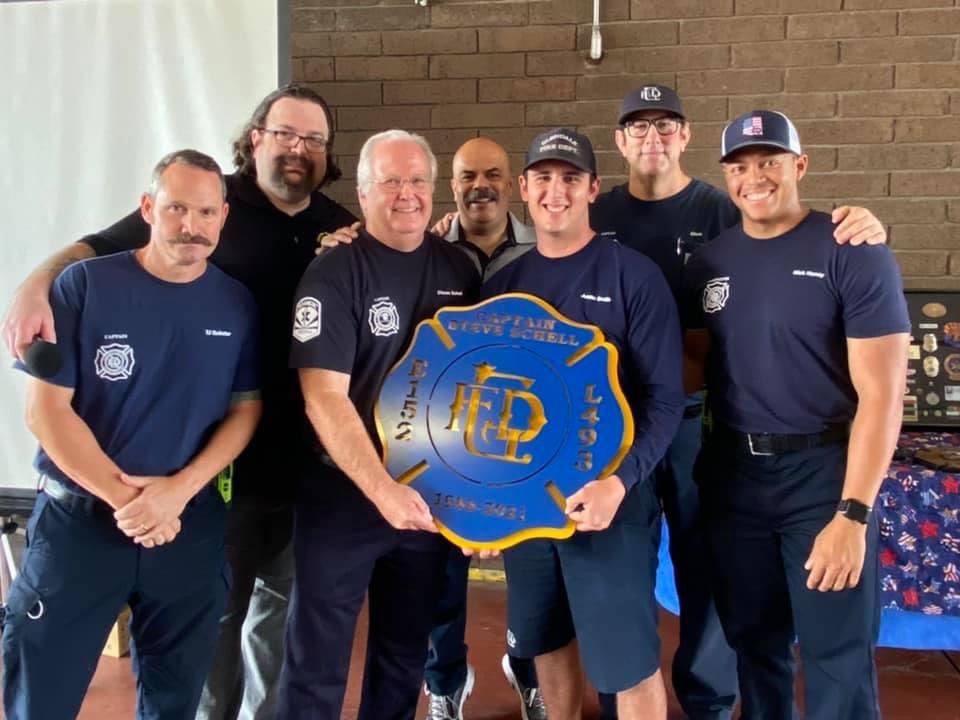 Crew presenting a captain's retirement plaque
