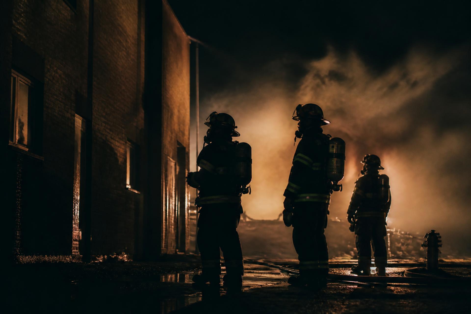 Firefighters working at night in full turnout gear